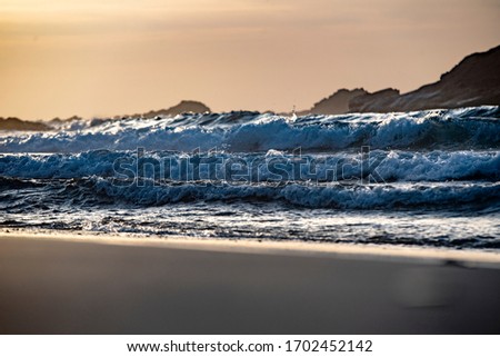 Waves breaking at sunset on a beach on the Vincentian coast, Portugal