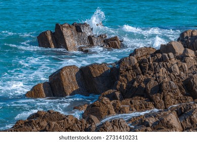Waves crashed against the black hexagonal volcanic rock columns.