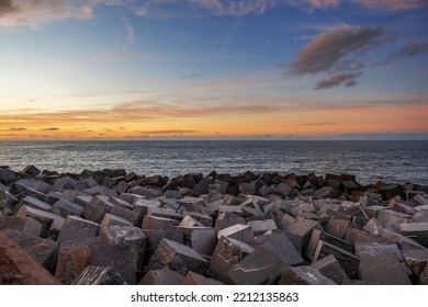 Waves  crashing against the breakwater at sunset - Shutterstock ID 2212135863