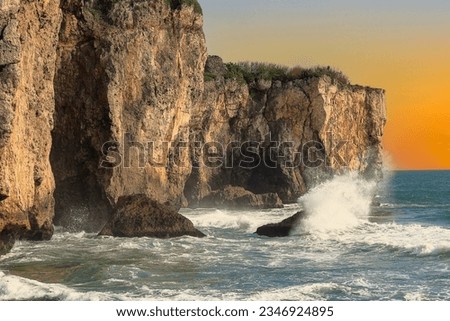 Waves crashing against rock on the shore.Fierce, tumbling wave view, and jumping spray scene are  over the vast sea.Regrettably touching scenic photo were photographed in Cijin, Kaohsiung, Taiwan