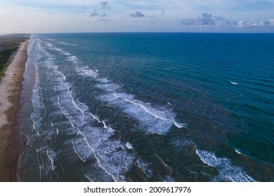 Waves Crashing Along The Endless Beach Over South Padre Island Beach , Texas , USA  Aerial Drone View Above Gorgeous South Texas Beach Vacation Destination