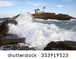 Waves crashing along the shoreline near Nubble (Cape Neddick) lighthouse in Maine.