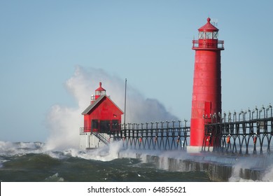 Waves crashing on lighthouse. Grand Haven lighthouse on Lake Michigan. Horizontal format.