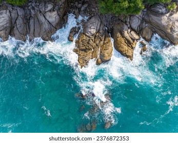 Waves crashing on seashore rocks,Top view sea surface waves background - Powered by Shutterstock