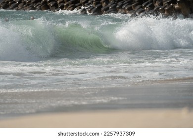 Waves crashing onto the shoreline during a storm - Shutterstock ID 2257937309