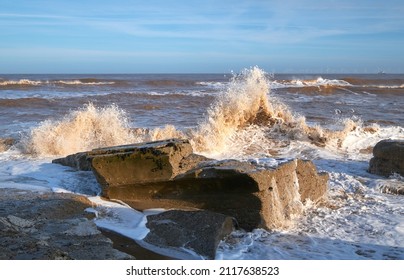 Waves crashing over rocks on a beach
 - Shutterstock ID 2117638523