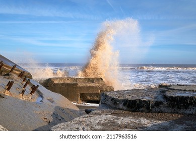 Waves crashing over rocks on a beach
 - Shutterstock ID 2117963516