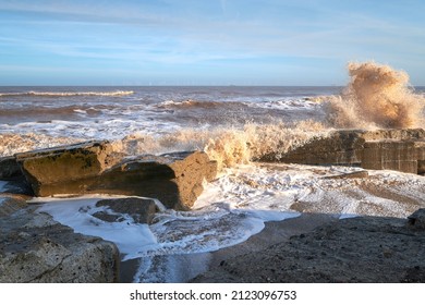 Waves crashing over rocks on a beach
 - Shutterstock ID 2123096753