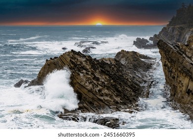 waves crashing at sunset on rocky shore at Shore Acres State Park, Oregon coast - Powered by Shutterstock