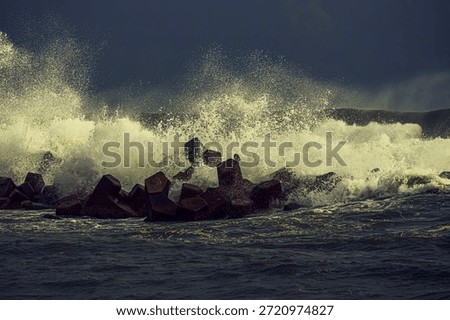 The waves hit the wave-breaking blocks to form stunning and beautiful waves Amazing power of nature For branding,calendar,postcard,screensaver,wallpaper,poster,banner,cover,website High quality photo