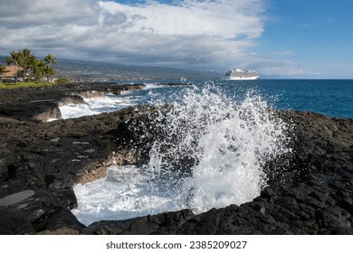 Waves hitting the beautiful rocky coast in Kona with a modern cruise ship anchored in the distance - Kona, Hawaii, USA - Powered by Shutterstock