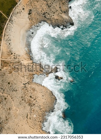 Aerial Drone View Of Dramatic Ocean Waves Crushing On Rocky Landscape