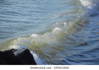 the waves hitting the rocks 