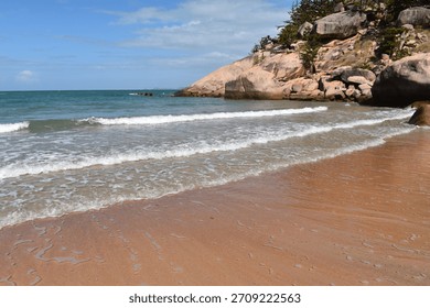 Waves lapping the sandy beach at Alma Bay, Magnetic Island, Queensland, Australia