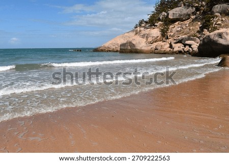 Waves lapping the sandy beach at Alma Bay, Magnetic Island, Queensland, Australia