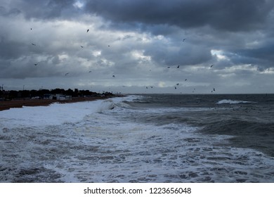 waves and light rays on stormy beach 