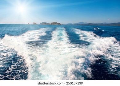 Waves On Blue Sea Behind The Speed Boat Water With Bright Sun Shining On The Sky