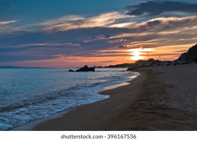 Waves on a sandy beach at sunset, west coast of Sithonia, Greece