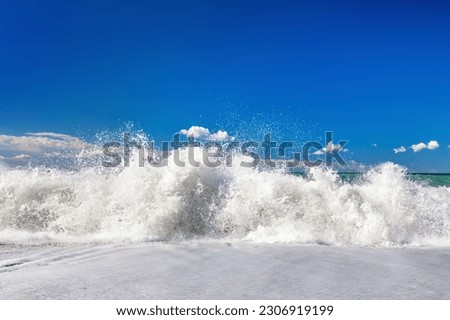Waves on sandy Italian beach at sunny summer day