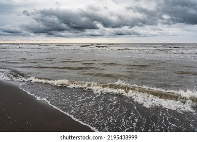 Waves On The Sea Beach On A Cloudy Rainy Day