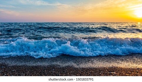 Waves On The Seashore At Sunset.