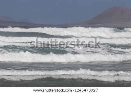 Waves, one after another, running onto the beach of Caleta De Famara, Lanzarote Island, Spain