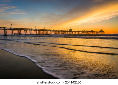 Waves in the Pacific Ocean and the fishing pier at sunset, in Imperial Beach, California. Stock Photo