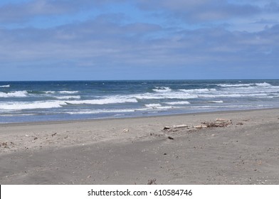 The Waves Of The Pacific Ocean Meets The Beach With Debris At Ocean Shores, WA, USA.