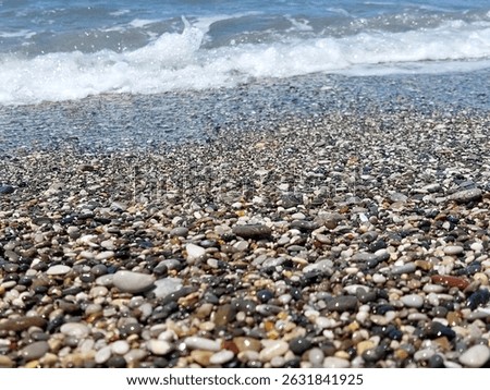 Waves and pebbles on the beach close-up