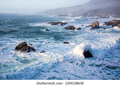 Waves And Rocky Shoreline On The Monerey Peninsula In Afternoon Light.  The Ever Changing Light And The Weather Create Endless Opportunities For Great Seascapes.