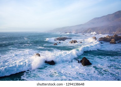 Waves And Rocky Shoreline On The Monerey Peninsula In Afternoon Light.  The Ever Changing Light And The Weather Create Endless Opportunities For Great Seascapes.