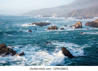 Waves And Rocky Shoreline On The Monerey Peninsula In Afternoon Light.  The Ever Changing Light And The Weather Create Endless Opportunities For Great Seascapes.