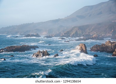 Waves And Rocky Shoreline On The Monerey Peninsula In Afternoon Light.  The Ever Changing Light And The Weather Create Endless Opportunities For Great Seascapes.