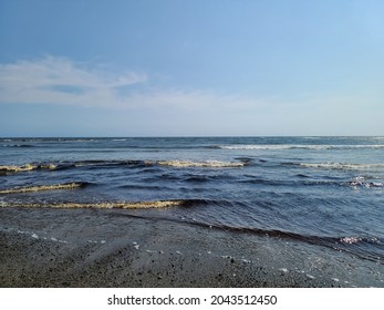 Waves rolling in at a beach.