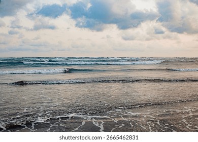 Waves Rolling on a Cloudy Day, dramatic waves, beautiful beach.