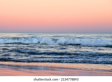 Waves At Sea On Dramatic Sunset Background. Waves At Sea During Storm And Wind. Out Of Focus, Possible Granularity, Motion Blur. 
