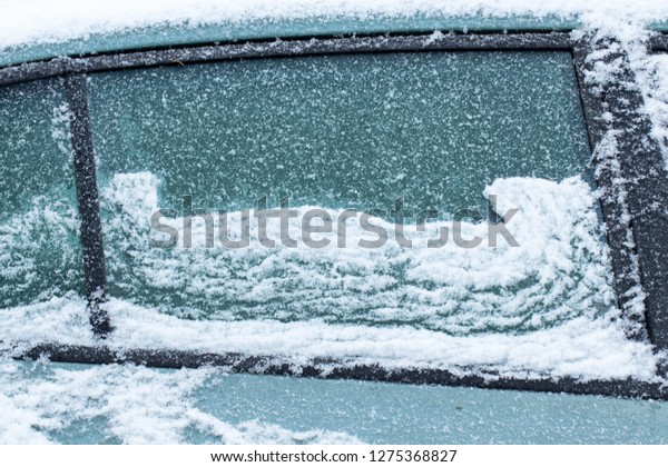 Waves of snow on car window\
