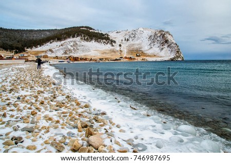 Waves and splash on Lake Baikal with rocks and trees near Uzuri village. Russia, Siberia