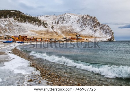 Waves and splash on Lake Baikal with rocks and trees near Uzuri village. Russia, Siberia