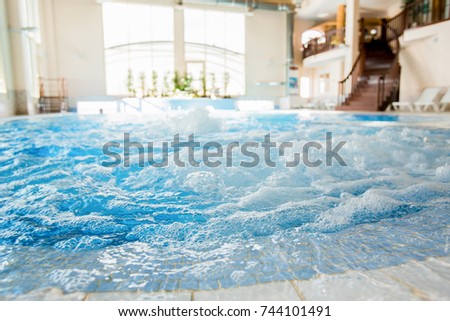 Waves and splashes in warm spa whirlpool with nobody around