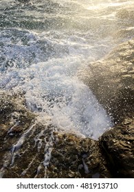 Waves splashes when hit rock.