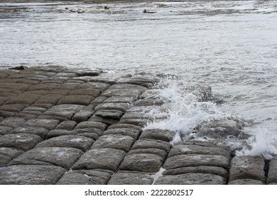 Waves splashing on the tessellated pavement on the edge of Pirates Bay, Tasmania - Shutterstock ID 2222802517