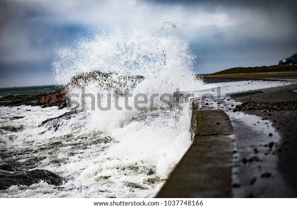 Waves and storm surge crash over Ocean Drive in\
Newport Rhode Island. The waves were after the March 2 Nor\'easter\
that hit the East Coast. Powerful waves crash against the seawall\
and into the road