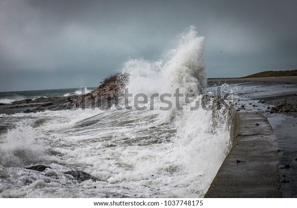 Waves and storm surge crash over Ocean Drive in\
Newport Rhode Island. The waves were after the March 2 Nor\'easter\
that hit the East Coast. Powerful waves crash against the seawall\
and into the road