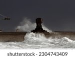 Waves in a stormy afternoon, hitting the north wall of Leixoes, near the old crane "Titan", builder of the harbor and now part of industrial archeology