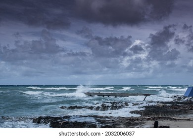 Waves from tropical storm Ida as it blows through the Cayman Islands pummel the dock in West Bay