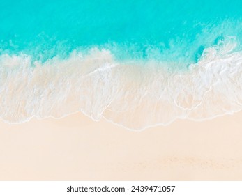 waves from the turquoise water of Grace Bay Beach, Providenciales gently break on the  empty white sand beach, seen from a top down aerial view with no people in photo - Powered by Shutterstock