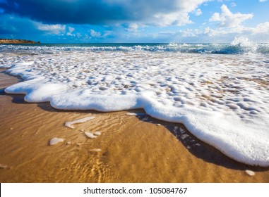 Waves Wash Over Golden Sand On Australian Beach