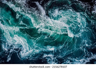 Waves of water of the river and the sea meet each other during high tide and low tide. Whirlpools of the maelstrom of Saltstraumen, Nordland, Norway - Shutterstock ID 2156278107