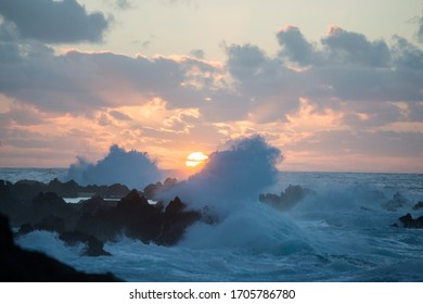 waves and wind by sunset on the coast at the Town Porto Moniz on the Island of Madeira in the Atlantic Ocean of Portugal.  Madeira, Porto Moniz, April, 2018